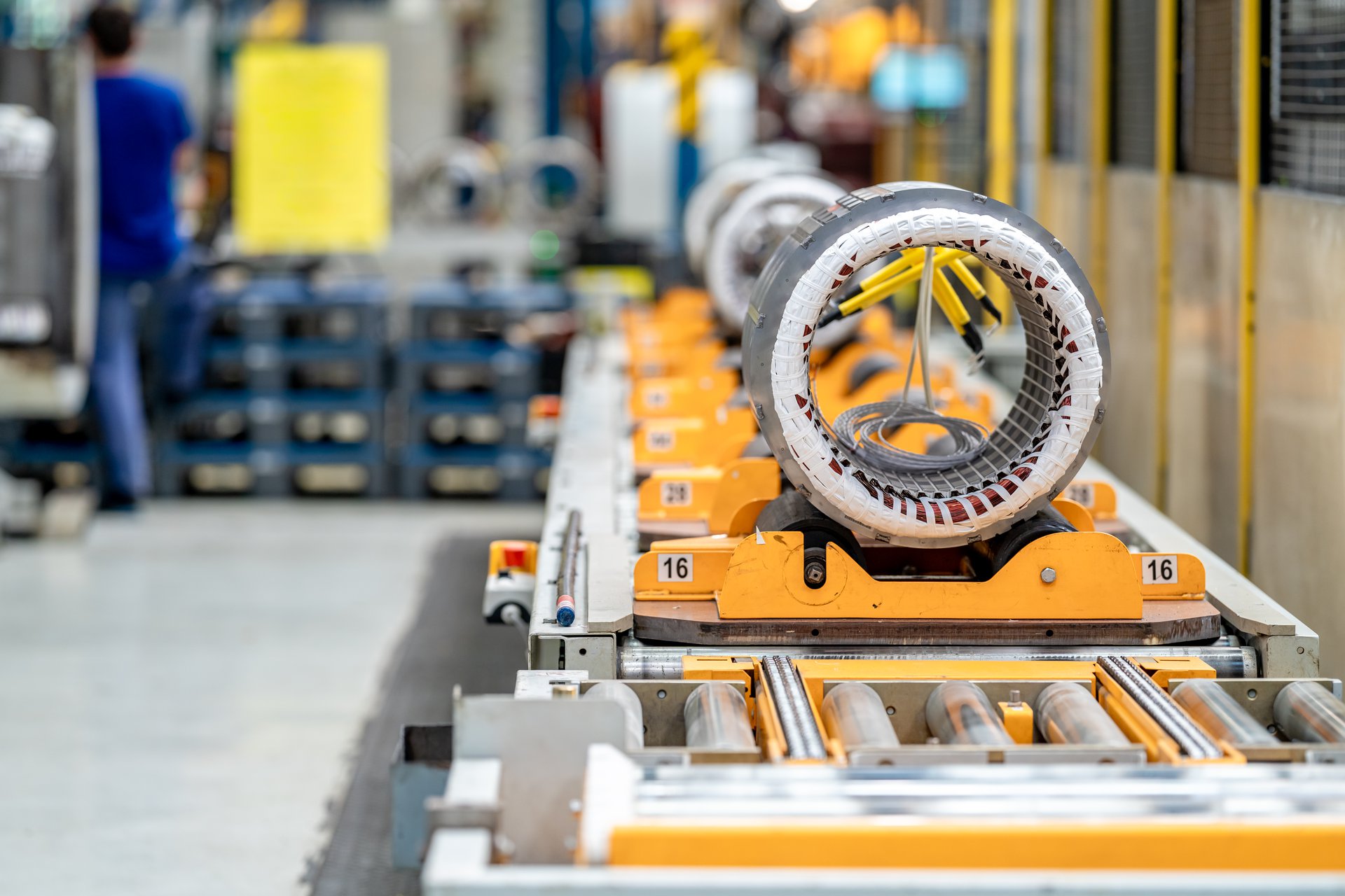 A close detail of an electric motor on a production line, the kind of rotating equipment predictive maintenance watches for early signs of failure