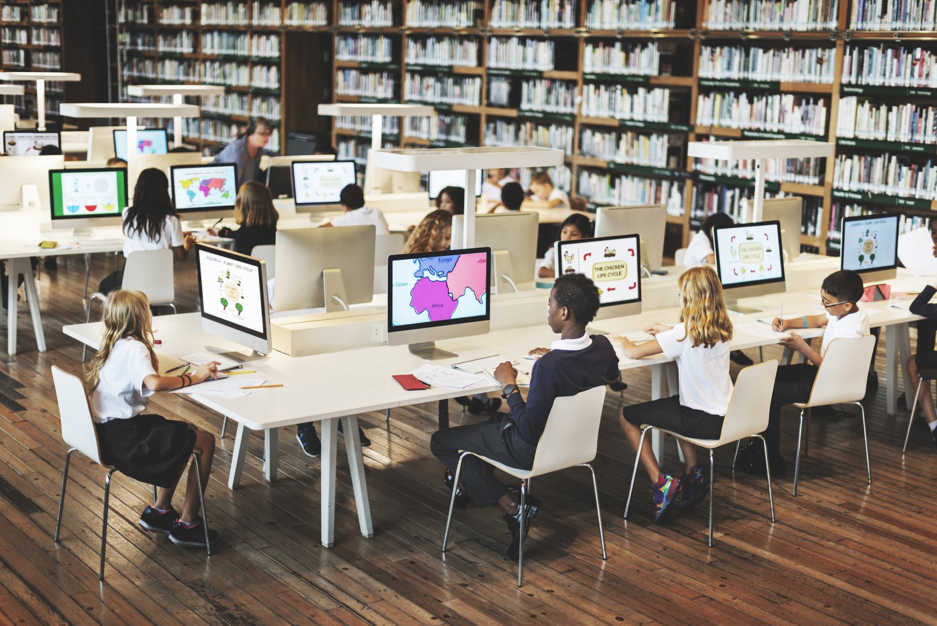 Students using computers together in a classroom, representing the learners an online university's enrolment agent supports